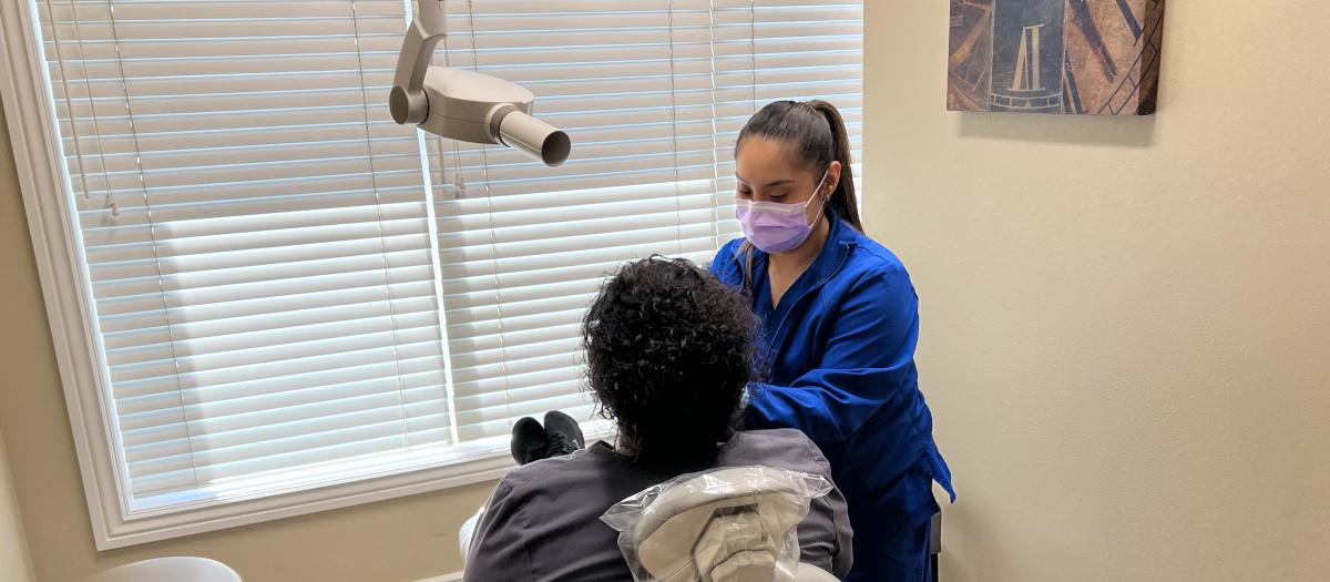 Angelica Gomez takes dental films of a patient.